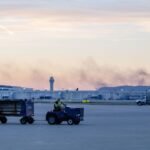 The ATC tower is seen while smoke rises from the crash site of UPS Flight 2796 near Louisville Muhammad Ali International Airport on Wednesday. Jon Cherry/AP